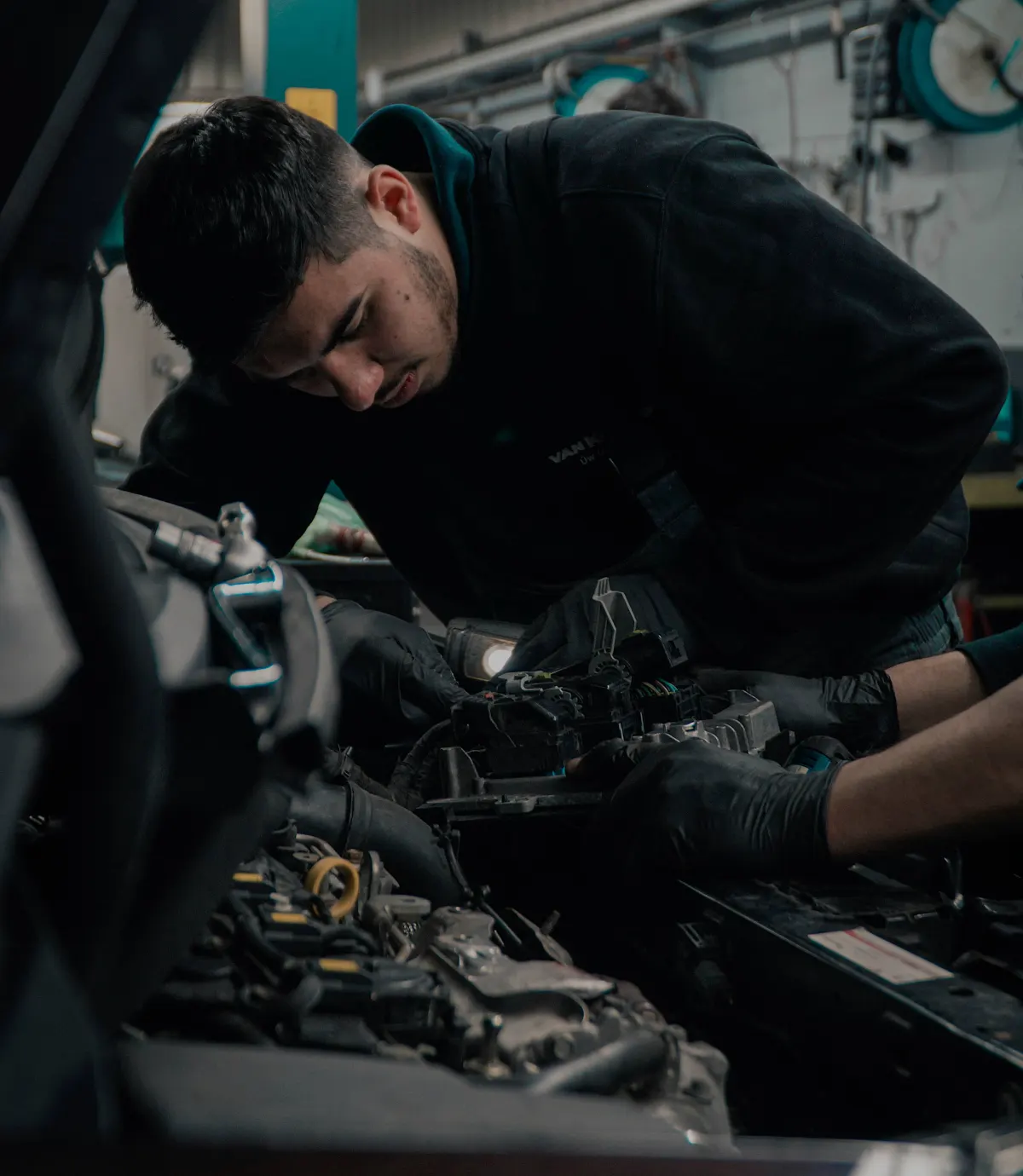 Roberto, founder of RCG Motors, working on a car engine